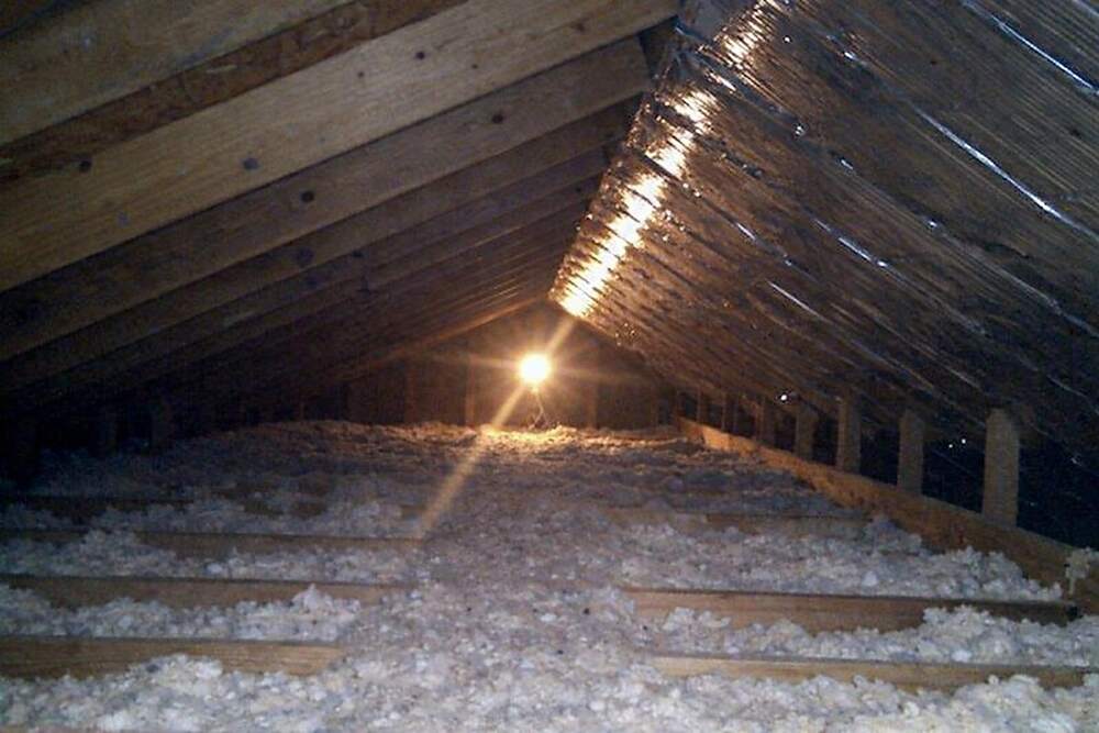 Exposed rafters inside a vented attic lit from one end