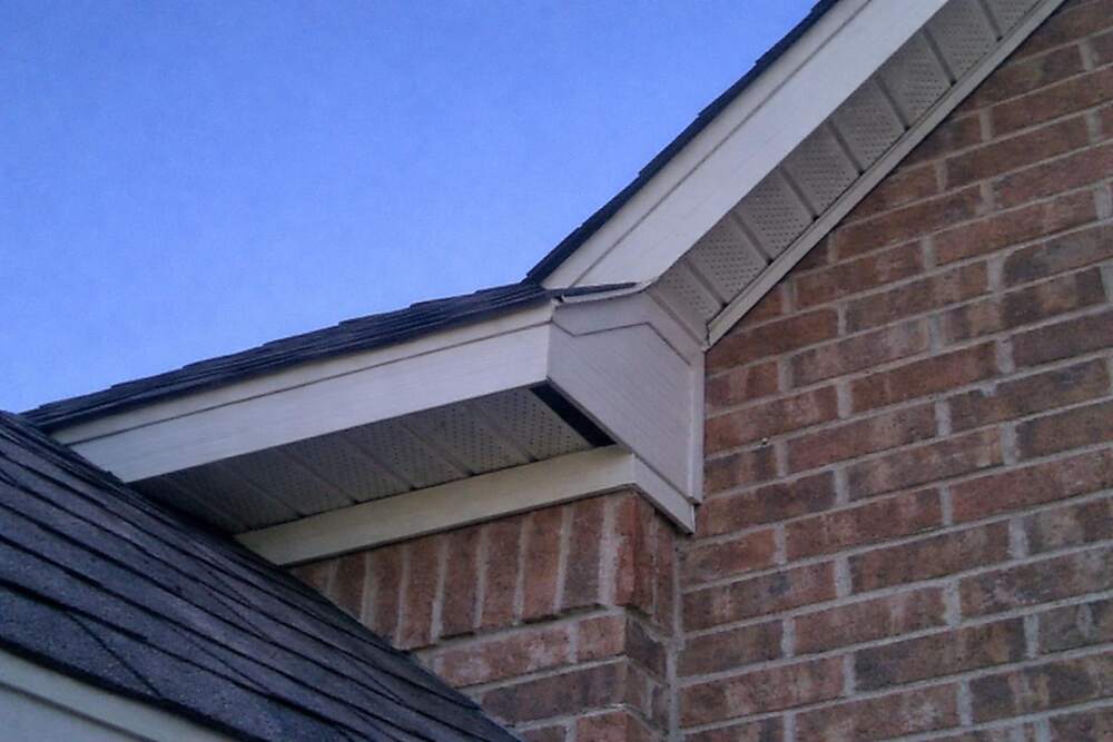 The roofline of a new house where the roof deck meets the wall