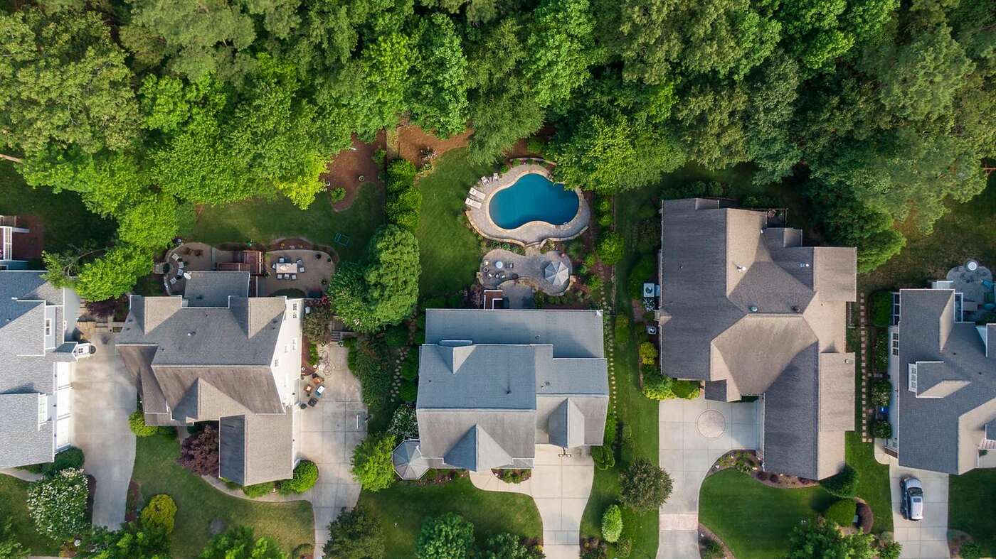 A large house set back on a wooded lot