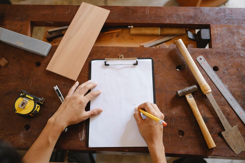 A clipboard with a checklist and a pen resting on a work surface