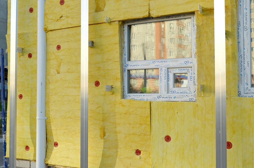 Fiberglass insulation batts stacked on a floor