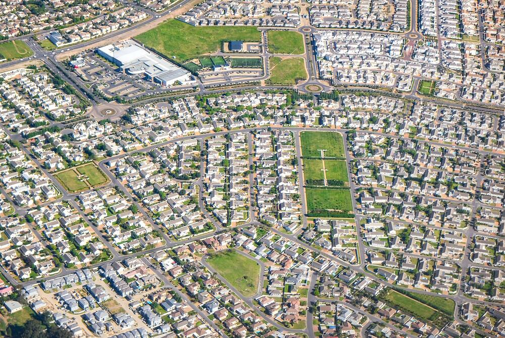 Aerial view of a North Texas suburb with brick houses and composition shingle roofs