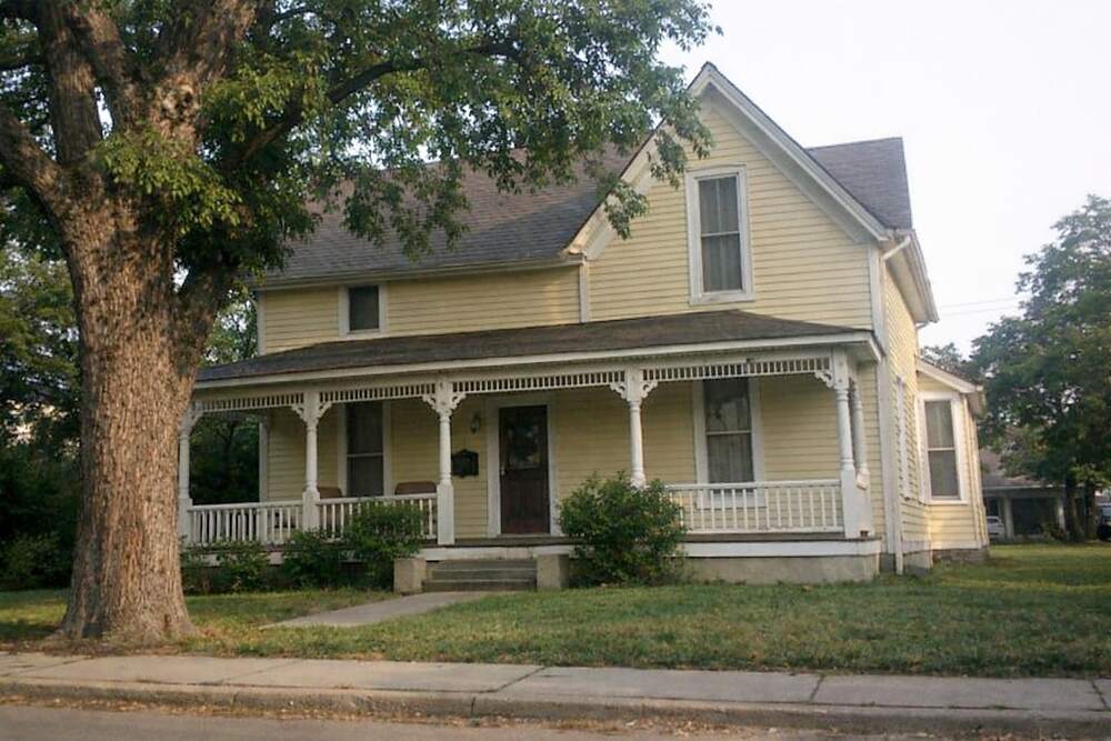An older wood-frame house with a deep front porch
