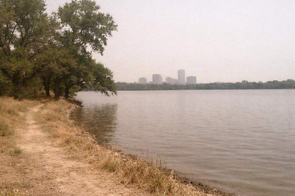 The wooded shoreline of White Rock Lake